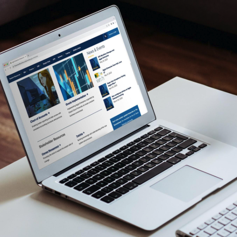 decorative image - laptop with aggie enterprise homepage displayed